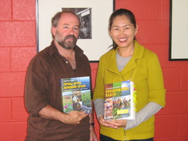 Jeff Conant and Oyungerel Tsedevamba hold Mongolian and English copies of Environmental Helath Book